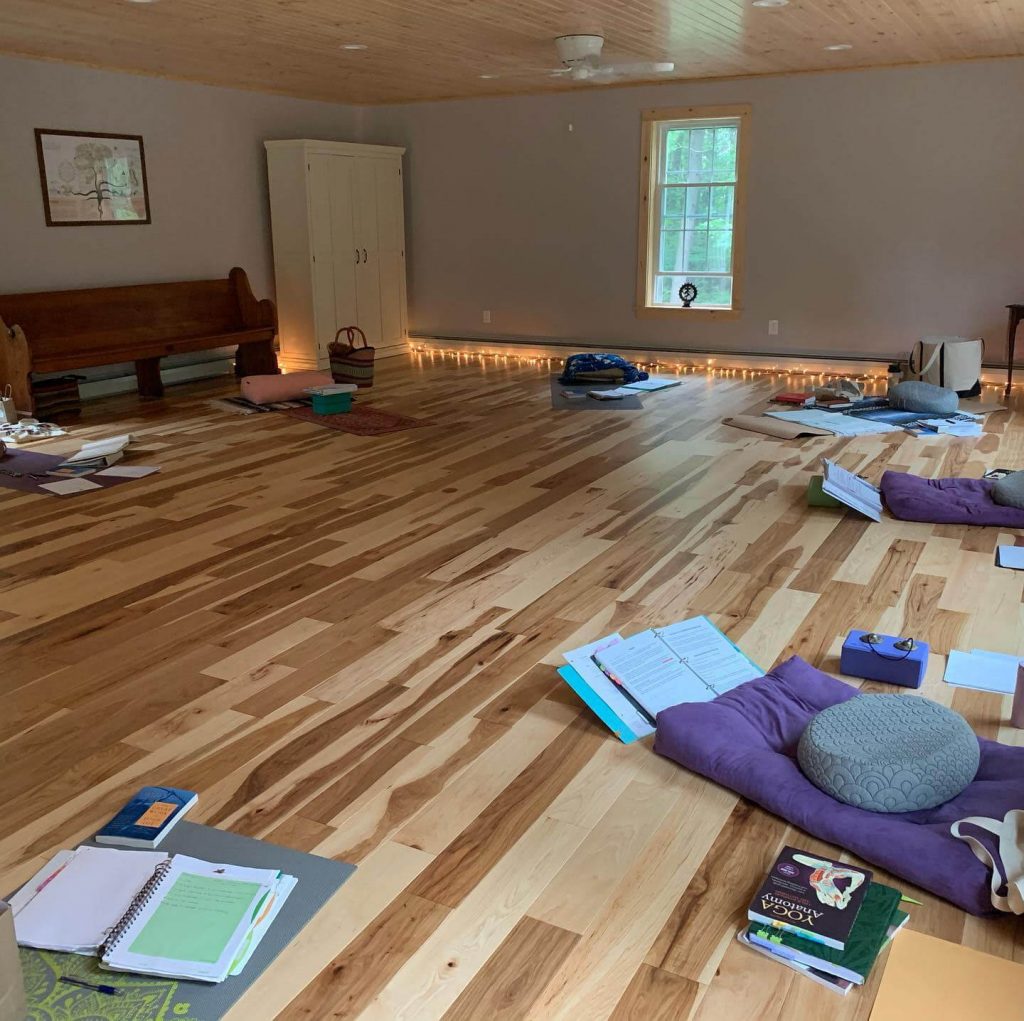 An indoor yoga studio with yoga mats around the room