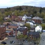 Aerial view of the town. There are a number of houses and buildings overlooking the mountain.