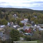 Aerial view of the town. There are a number of houses and buildings overlooking the mountain.